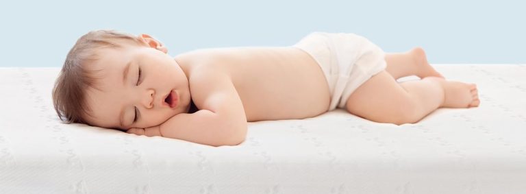 Baby sleeping on baby mattress
