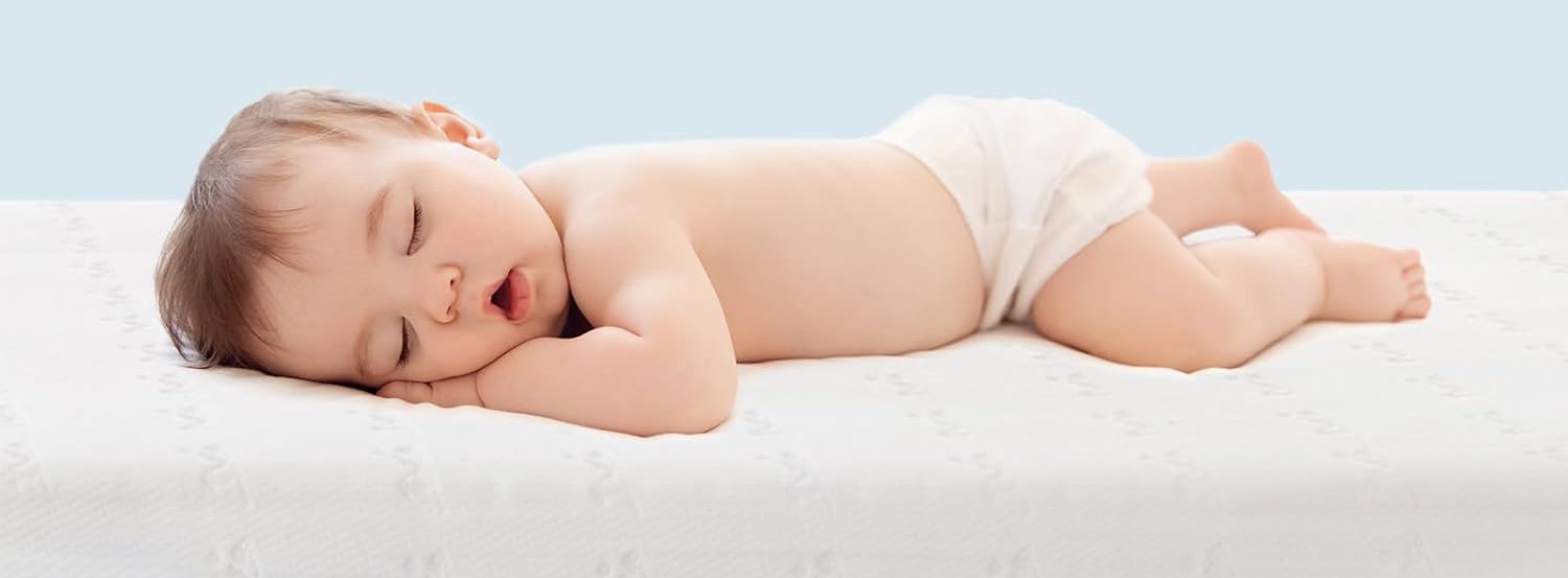Baby sleeping on baby mattress